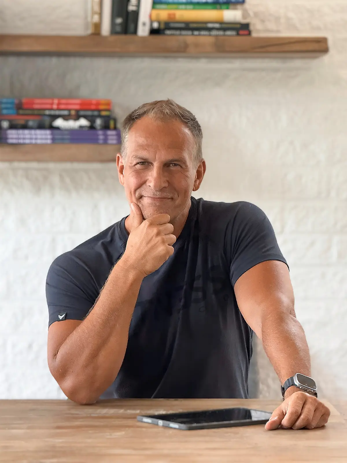 Porträt von Achim Loobes von Achim Loobes, dem Solo-Entwickler von VigiGym, an einem Holztisch mit iPad in Breskens